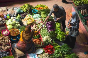 A person selling vegetables at a market