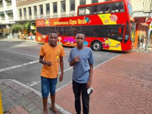 Modisha's Cousins Standing Next to the City Sightseeing Bus
