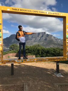Modisha standing in front of a frame near Table Mountain